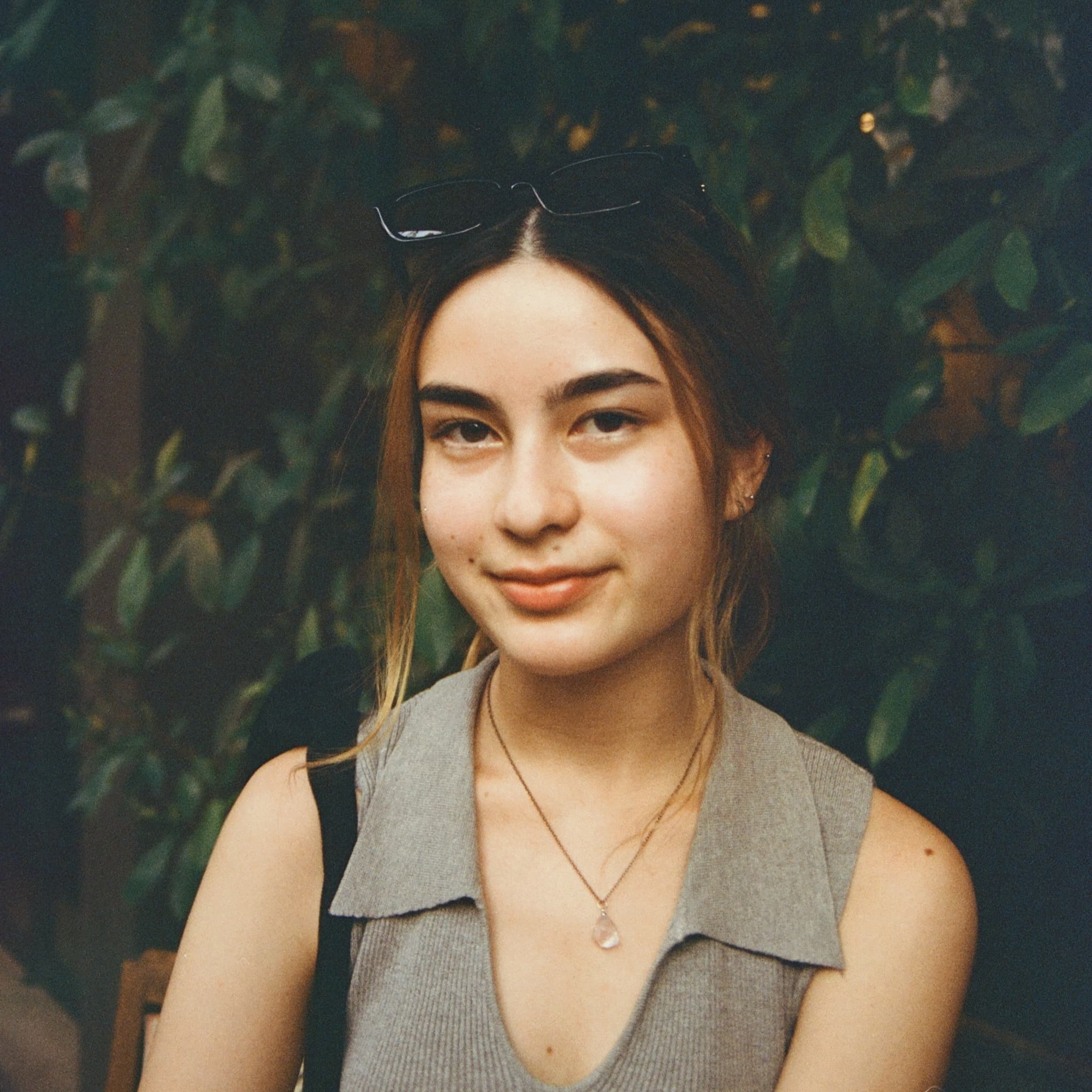 Stella posing in front of a white wall